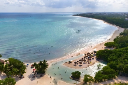 Sunset at Punta Esmeralda beach with calm waters and natural cenote