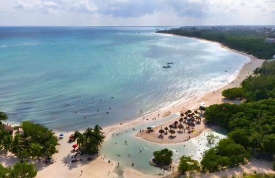 Sunset at Punta Esmeralda beach with calm waters and natural cenote